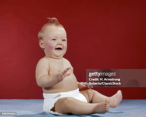 1960S BABY WEARING CLOTH DIAPER SITTING UP LAUGHING HAPPY