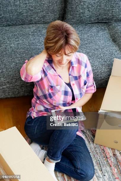 senior woman moving into a new apartment - letting it all hang out stock pictures, royalty-free photos & images