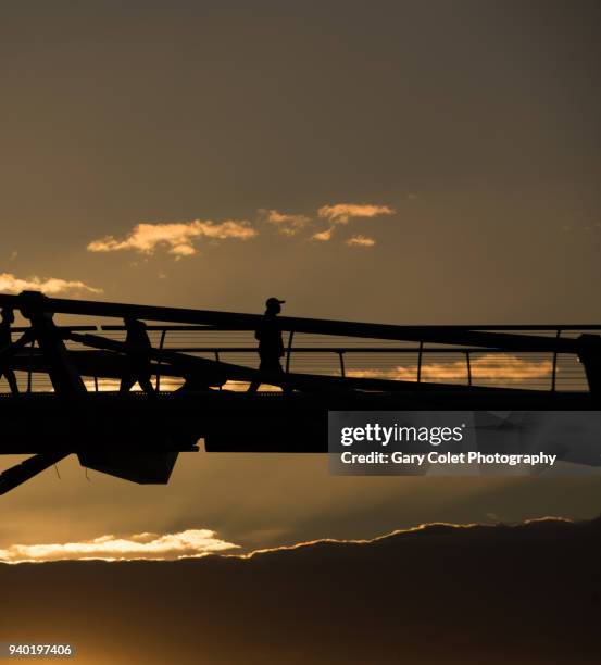 walker silhouetted on millennium bridge - gary colet stock pictures, royalty-free photos & images