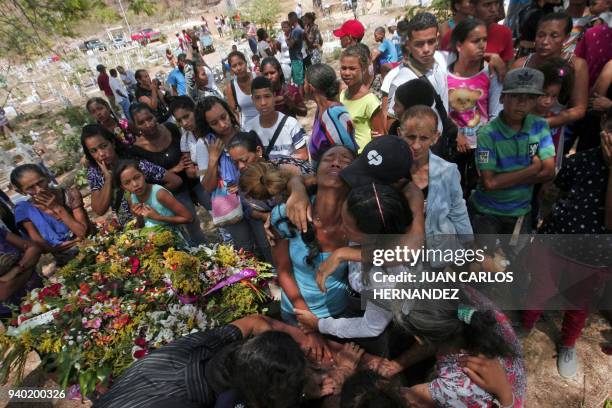 Relatives grieve during the funeral of some of the victims of the prison fire, in Valencia, northern Carabobo state, Venezuela, March 30, 2018. A...