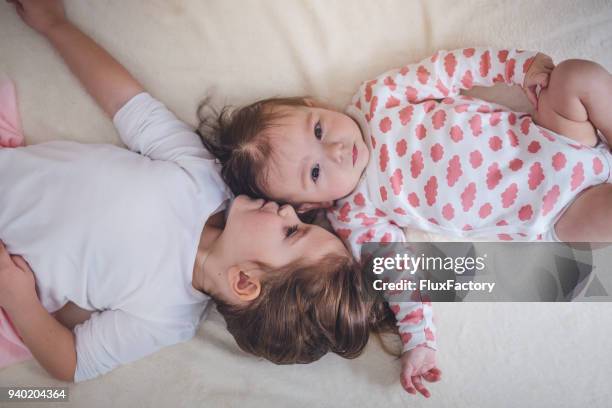 love for a baby sister - sister stock pictures, royalty-free photos & images