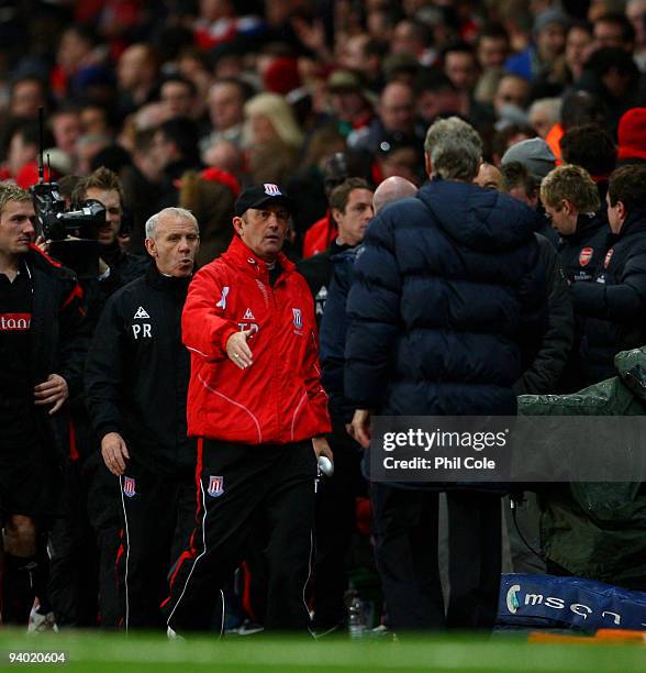 Tony Pulis manager of Stoke City shakes hands with Arsene Wenger manager of Arsenal during the Barclays Premier League match between Arsenal and...