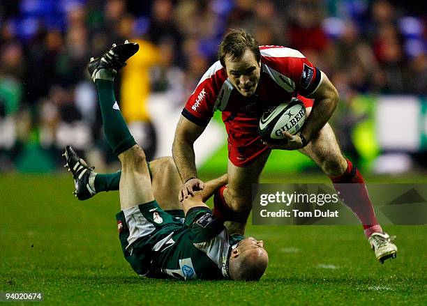 Paul Hodgson of London Irish tackles running with the ball Tom Wood of Worcester Warriors during the Guinness Premiership match between London Irish...