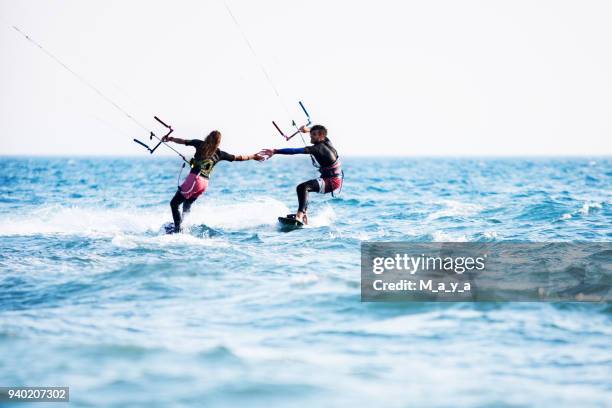 paar kitesurfen samen - windrad energie stockfoto's en -beelden