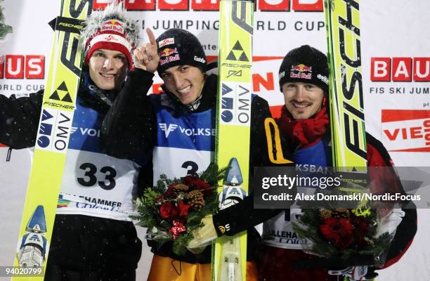 Winner Gregor Schlierenzauer of Austria poses on the Podium together with Thomas Morgenstern of Austria who placed second and Adam Malysz of Poland...