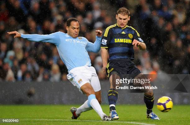 Branislav Ivanovic of Chelsea competes for the ball with Joleon Lescott of Manchester City during the Barclays Premier League match between...
