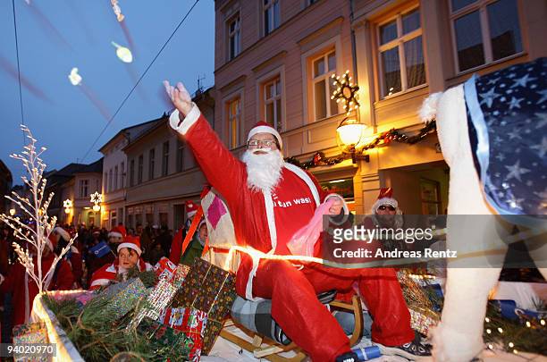 Man dressed in a Santa Claus outfit sits on a sledge during the 11th Santa Clauses parade on December 5, 2009 in Brandenburg, near Berlin, Germany....