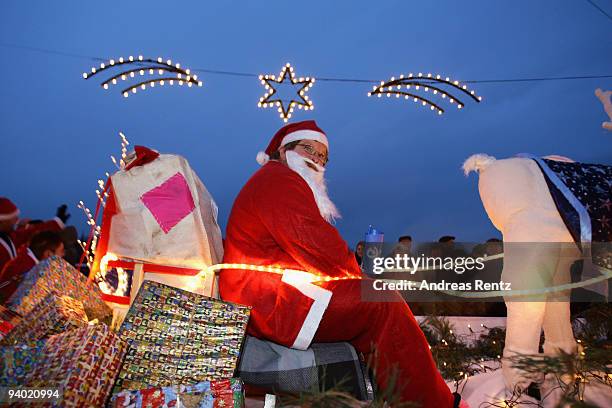 Man dressed in a Santa Claus outfit sits on a sledge during the 11th Santa Clauses parade on December 5, 2009 in Brandenburg, near Berlin, Germany....