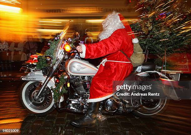 Man dressed in a Santa Claus outfit rides on his motor bike during the 11th Santa Clauses parade on December 5, 2009 in Brandenburg, near Berlin,...