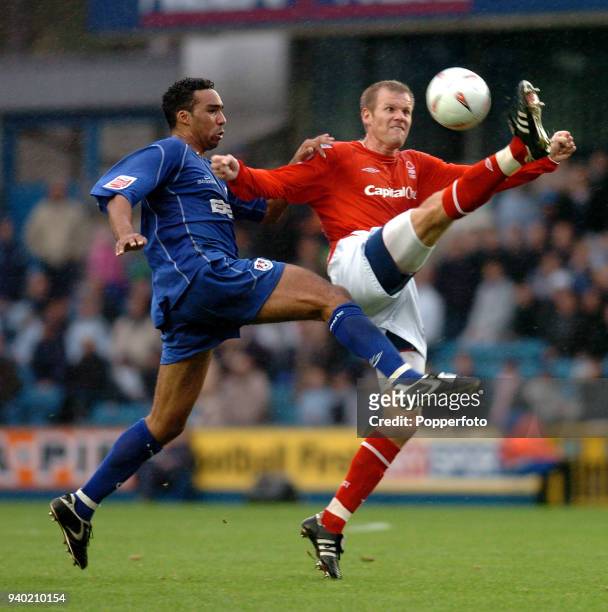 Paul Ifill of Millwall challenges Jon Olav Hjelde of Nottingham Forest during the Coca-Cola Championship League match between Millwall and Nottingham...
