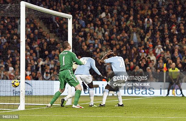 Manchester City's Irish goalkeeper Shay Given cannot stop the ball crossing his goal-line after deflecting off team-mate Togolese striker Emmanuel...