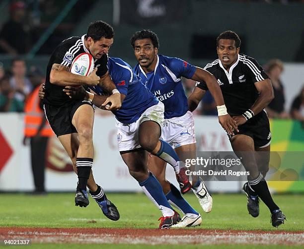 Zar Lawrence of New Zealand is tackled by Afa Aiono of Samoa in the final match during the IRB Sevens tournament at the Dubai Sevens Stadium on...