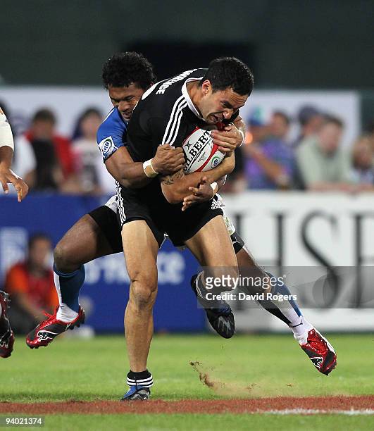 Zar Lawrence of New Zealand is tackled by Afa Aiono of Samoa in the final match during the IRB Sevens tournament at the Dubai Sevens Stadium on...