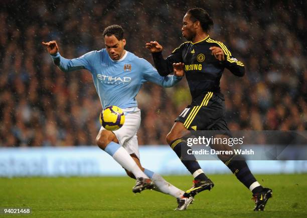 Joleon Lescott of Manchester City controls the ball under pressure from Didier Drogba of Chelsea during the Barclays Premier League match between...