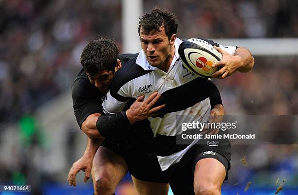 Bismark du Plessis of Barbarians is tackled by Corey Flynn of New Zealand during the MasterCard Trophy match between Barbarians and New Zealand at...