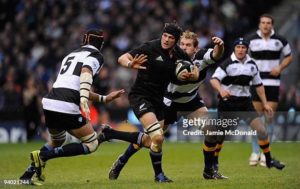 Richie McCaw of New Zealand holds off Victor Matfield of Barbarians during the MasterCard Trophy match between Barbarians and New Zealand at...