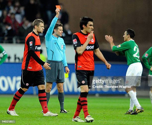 Referee Felix Brych shows the red card to Chadli Amri of Mainz during the Bundesliga match between Eintracht Frankfurt and FSV Mainz 05 at...