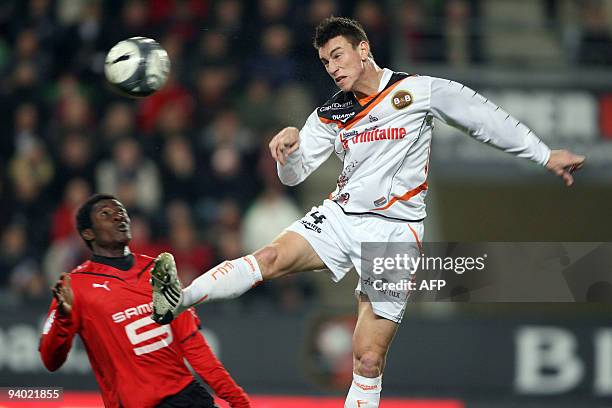 Rennes's forward Asamoah Gyan vies with Lorient's defender Laurent Koscielny during their French L1 football match Rennes vs Lorient, on December 5,...
