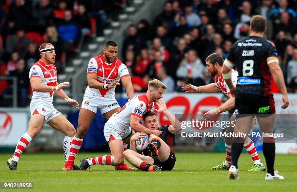 St Helens' Danny Richardson tackles Wigan's Joe Burgess during the Super League match at the Totally Wicked Stadium, St Helens.