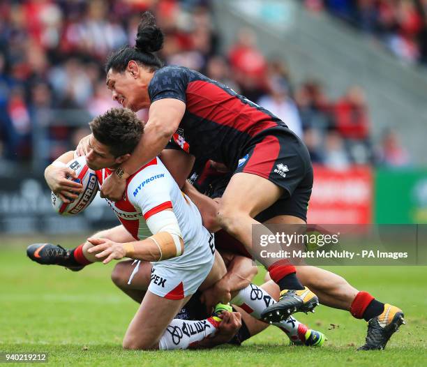Wigan Warriors' Taulima Tautai tackles St Helens' Louie McCarthy-Scarsbrook during the Super League match at the Totally Wicked Stadium, St Helens.
