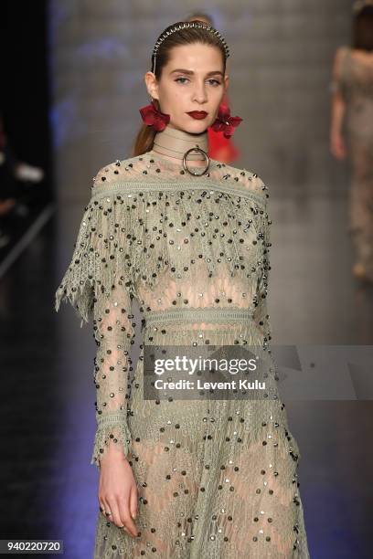 Model walks the runway at the Zeynep Tosun show during Mercedes Benz Fashion Week Istanbul at Zorlu Performance Hall on March 30, 2018 in Istanbul,...