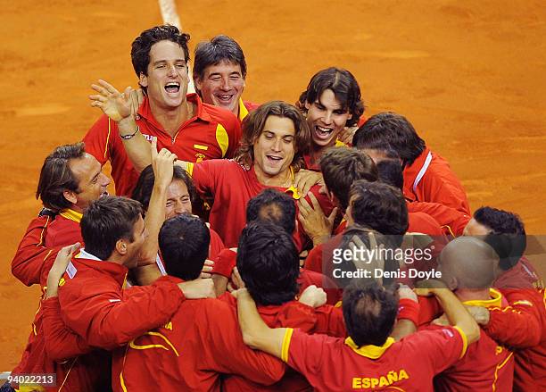 Feliciano Lopez , David Ferrer and Rafael Nadal of Spain celebrate with their team mates after Feliciano Lopez and Fernando Verdasco of Spain beat...