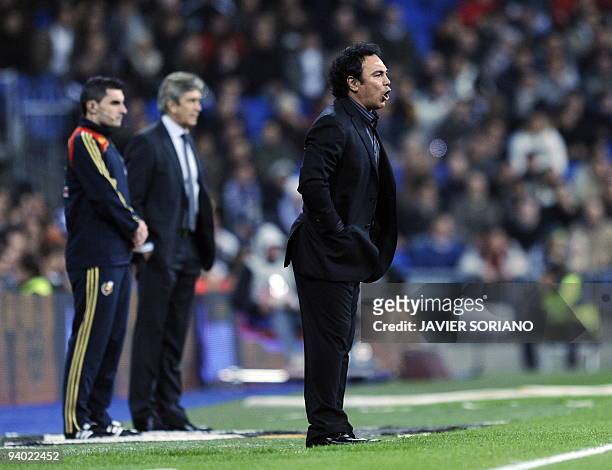 Almeria's Mexican coach Hugo Sanchez gives instructions to his players during a Spanish league football match at Santiago Bernabeu stadium on...