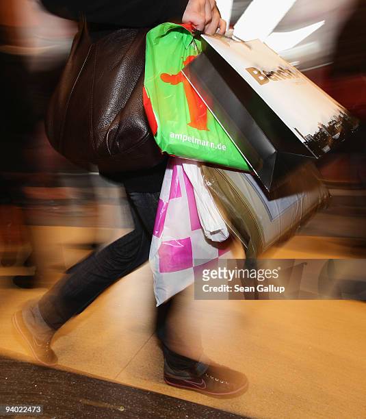 Shopper carries bags with recent purchases at the Alexa shopping mall on December 5, 2009 in Berlin, Germany. Retailers are hoping for a strong...