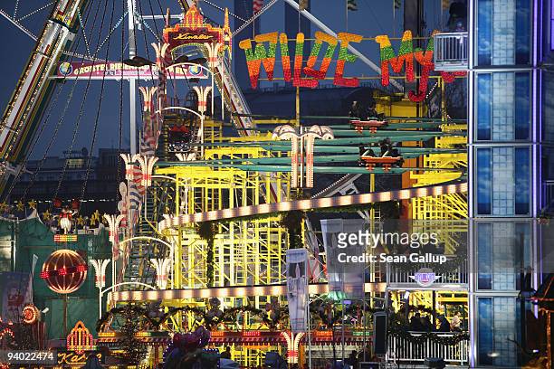 People crowd an amusement park with a rollercoaster next to the Alexa shopping mall on December 5, 2009 in Berlin, Germany. Retailers are hoping for...