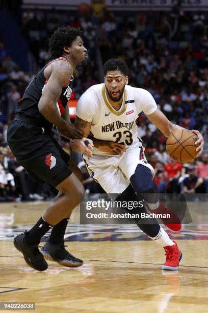 Anthony Davis of the New Orleans Pelicans drives against Ed Davis of the Portland Trail Blazers during the second half at the Smoothie King Center on...