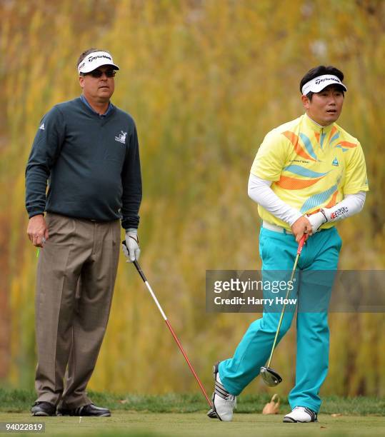 Yang of South Korea and Kenny Perry watch a shot on the fifth hole during the third round of the Chevron World Challenge at Sherwood Country Club on...