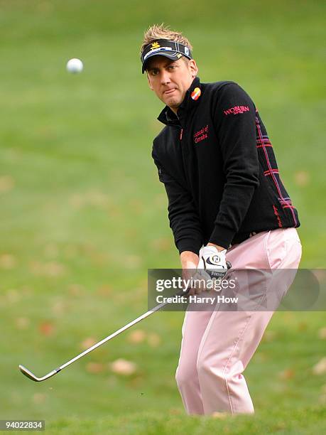 Ian Poulter of England watches his chip shot on the fourth hole during the third round of the Chevron World Challenge at Sherwood Country Club on...