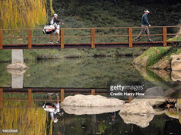 Kenny Perry crosses a bridge to the fourth tee during the third round of the Chevron World Challenge at Sherwood Country Club on December 5, 2009 in...