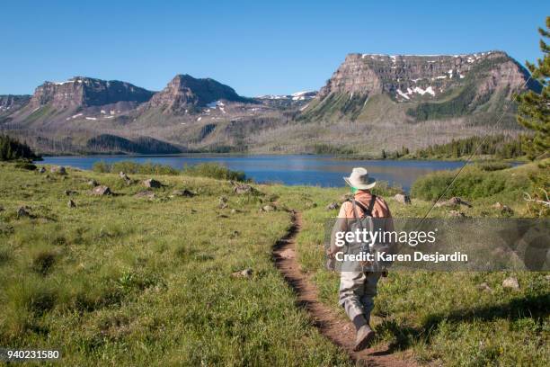 fisherman hiking trail to mountain lake, colorado - fisherman isolated stock pictures, royalty-free photos & images