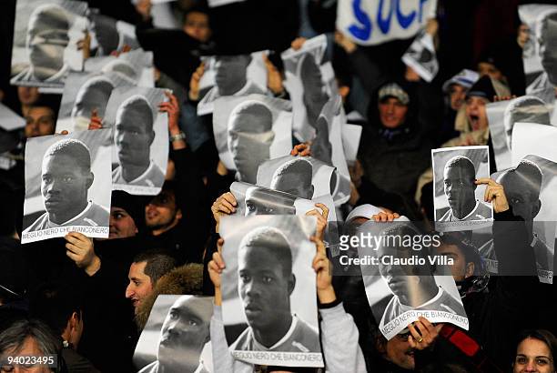 Fans of FC Internazionale Milano hold up posters of Mario Balotelli in response to racist abuse that the player received during last season's fixture...