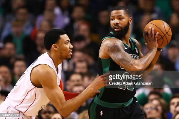 Otto Porter Jr. #22 of the Washington Wizards guards Marcus Morris of the Boston Celtics during a game at TD Garden on March 14, 2018 in Boston,...