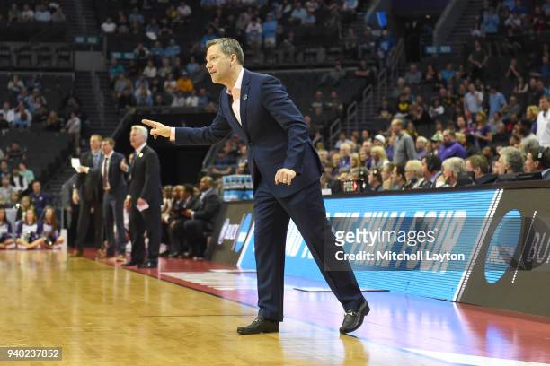 Head coach Ryan Odom of the UMBC Retrievers signals to his players during the second round of the 2018 NCAA Men's Basketball Tournament against the...