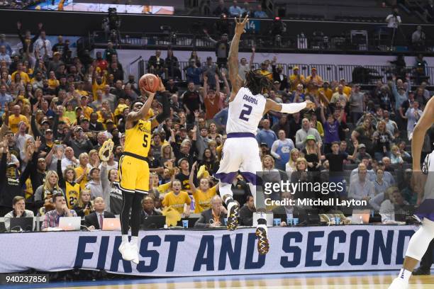 Jourdan Grant of the UMBC Retrievers takes a shot over Cartier Diarra of the Kansas State Wildcats during the second round of the 2018 NCAA Men's...