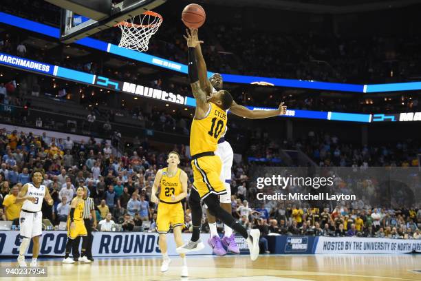 Jairus Lyles of the UMBC Retrievers drives to the basket over Makol Mawien of the Kansas State Wildcats during the second round of the 2018 NCAA...