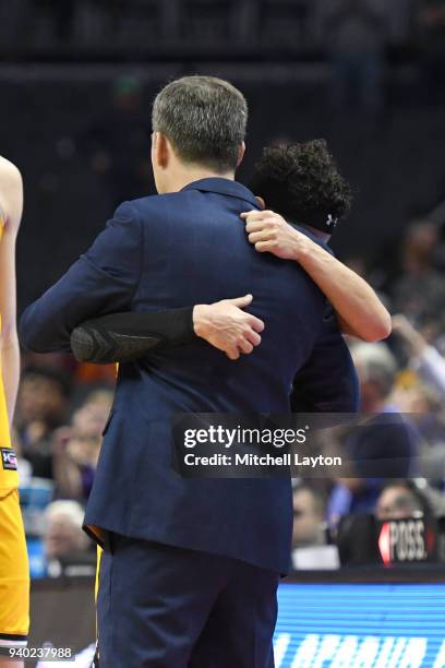 Head coach Ryan Odom of the UMBC Retrievers hugs K.J. Macura during the second round of the 2018 NCAA Men's Basketball Tournament against the Kansas...