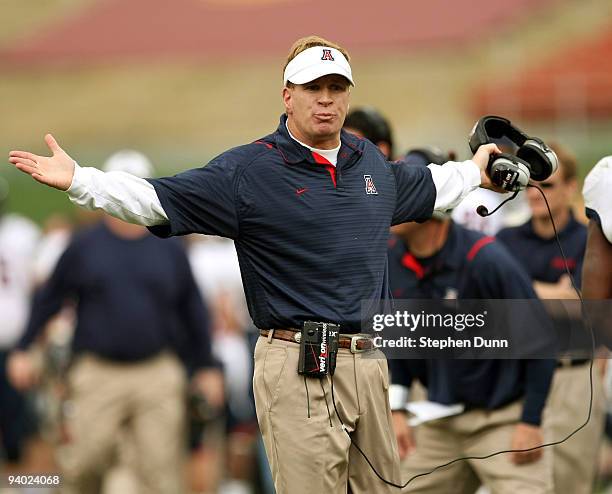 Head coach Mike Stoops of the Arizona Wildcats gestrures to an official during the game with the USC Trojans on December 5, 2009 at the Los Angeles...