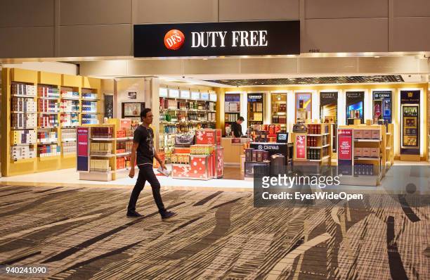 Duty Free, Alcohol Shops and Travellers at the International Changi Airport on November 02, 2013 in Singapore.