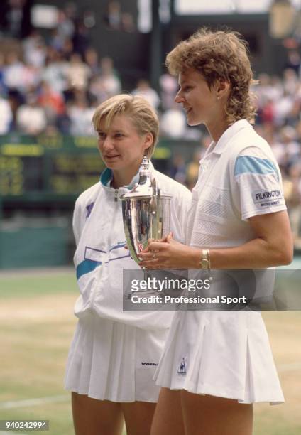 Jana Novotna and Helena Sukova both of Czechoslovakia pose with the trophy after defeating Larisa Savchenko and Natasha Zvereva both of the Soviet...