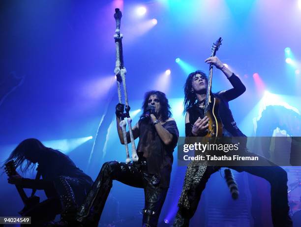 Damon Johnson, Alice Cooper and Keri Kelli perform on stage at the Brighton Centre on December 5, 2009 in Brighton, England.