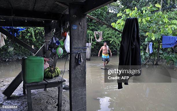 Bolivian Rosauro Noe walks at his yard flooded by the Chipiriri River on December 5, 2009 in Puerto San Francisco, Cochabamba departmment, 590 km...