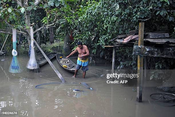 Bolivian Rosauro Noe walks at his yard flooded by the Chipiriri River on December 5, 2009 in Puerto San Francisco, Cochabamba departmment, 590 km...