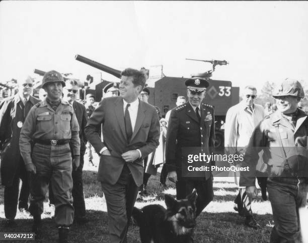 View of American politician US President John F Kennedy , accompanied by Commanding General of the 1st Armored Division Major General Ralph E Haines...