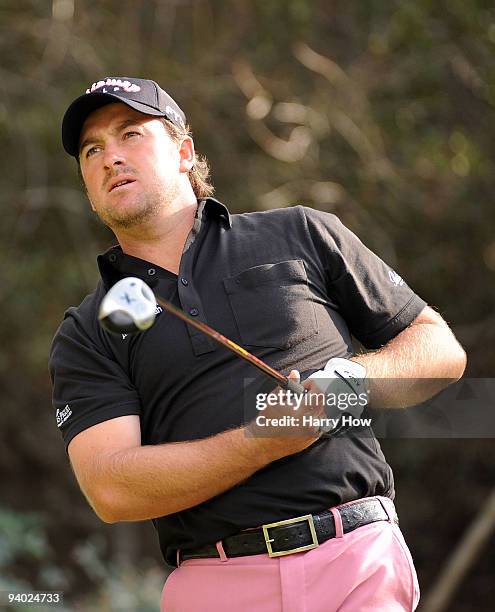 Graeme McDowell of Northern Ireland watches his tee shot on the 18th hole during the third round of the Chevron World Challenge at Sherwood Country...