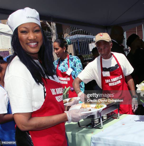 Actress Garcelle Beauvais, Helen Lasichanh and musician Pharrell Williams attend the Los Angeles Mission Easter charity event at the Los Angeles...