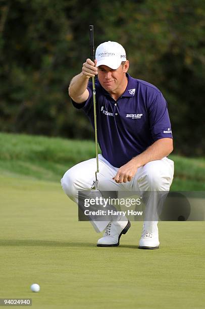 Lee Westwood of England lines up his putt on the 18th green during the third round of the Chevron World Challenge at Sherwood Country Club on...